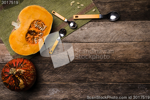 Image of Pumpkins with spoons on green napkin and wood in Rustic style 