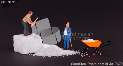 Image of Miniature worker working on a sugar cube