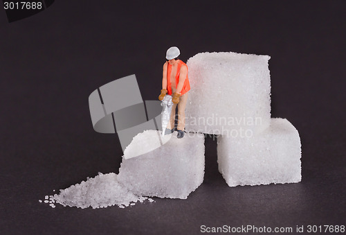 Image of Miniature worker working on a sugar cube