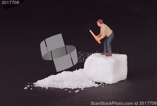 Image of Miniature worker working on a sugar cube