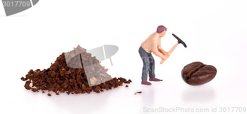 Image of Miniature worker working on a coffee bean