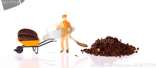 Image of Miniature worker working on a coffee bean