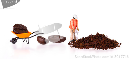 Image of Miniature worker working on a coffee bean