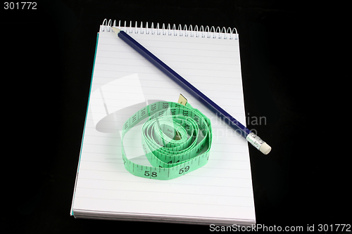 Image of Notepad Pencil and tape measure