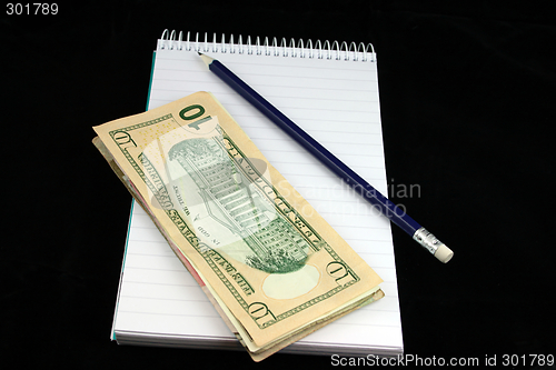 Image of Notepad Pencil and Money