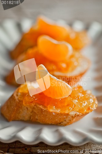 Image of pieces of baguette with orange marmalade