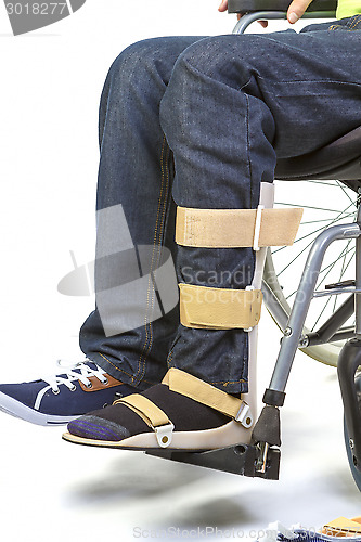 Image of Orthopedic equipment for young man in wheelchair - close up