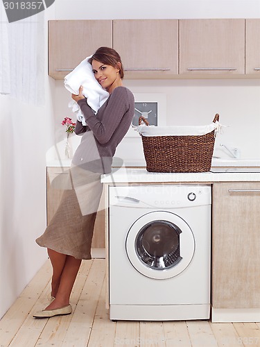 Image of smiling woman in the laundry room 