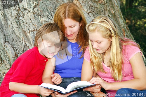 Image of Family reading a book