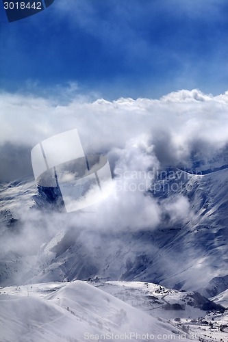 Image of Ski resort in mist and sunlight sky
