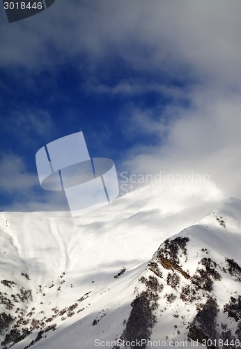 Image of View on off-piste sunlight slope in clouds