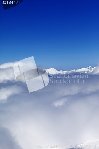 Image of Mountains under clouds and clear sunny sky