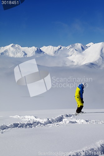 Image of Snowboarder on off-piste slope with new fallen snow