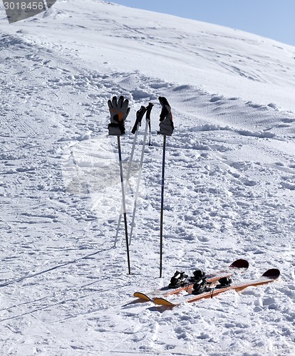 Image of Skiing equipment on ski slope at sunny day