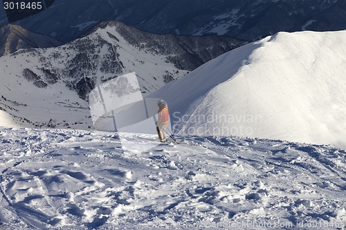 Image of Skier on off-piste slope in sun evening