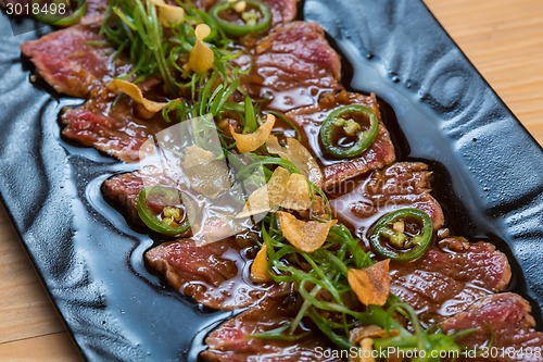 Image of Beef Carpaccio on dark background