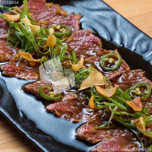 Image of Beef Carpaccio on dark background