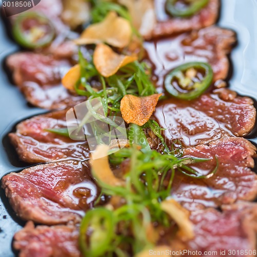 Image of Beef Carpaccio on dark background