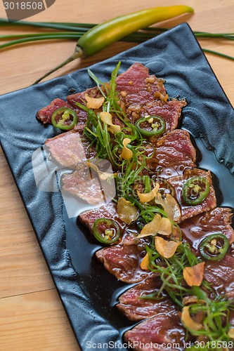 Image of Beef Carpaccio on dark background