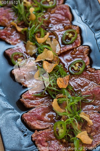 Image of Beef Carpaccio on dark background