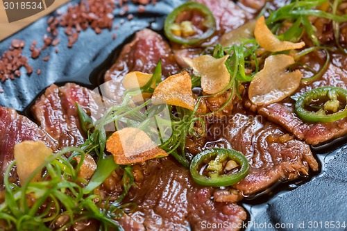 Image of Beef Carpaccio on dark background