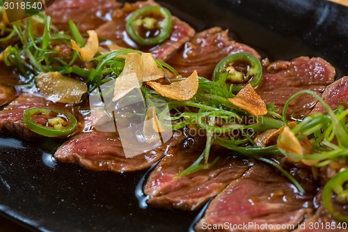 Image of Beef Carpaccio on dark background