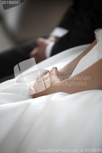 Image of Hands of a bride and a groom praying