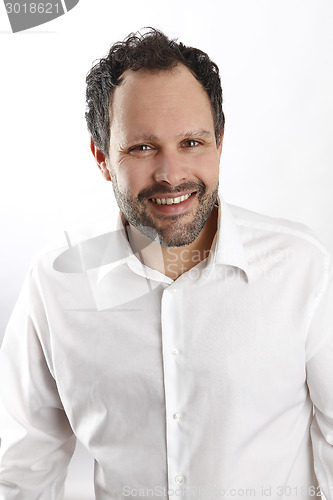 Image of Attractive man with white shirt  looks into the camera