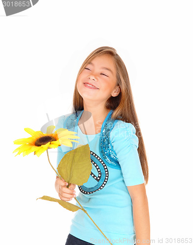 Image of Girl smiling with sunflower.
