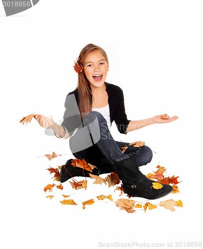 Image of Happy girl with falling leaves.