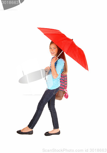 Image of Young girl walking with umbrella.