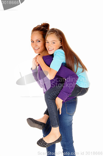 Image of Mother piggyback daughter.