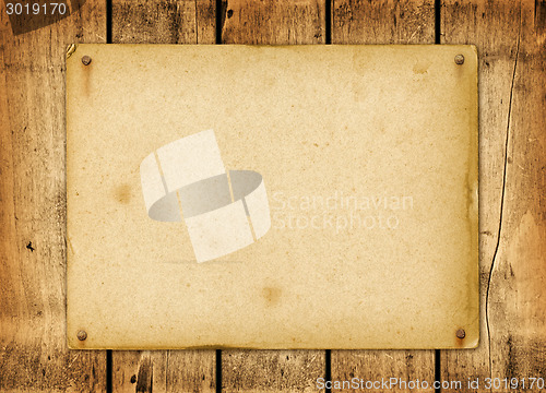 Image of Blank vintage poster nailed on a wood board