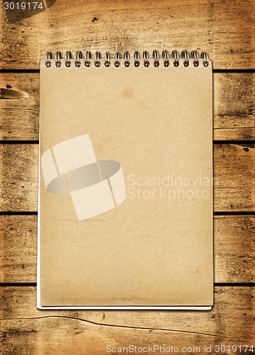 Image of Blank vintage notebook on a wood board