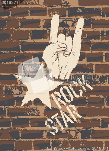 Image of Rock Star Sign With Horns Gesture On Brick Wall