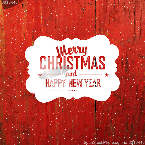 Image of Vintage Christmas Label On Red Hardwood Texture