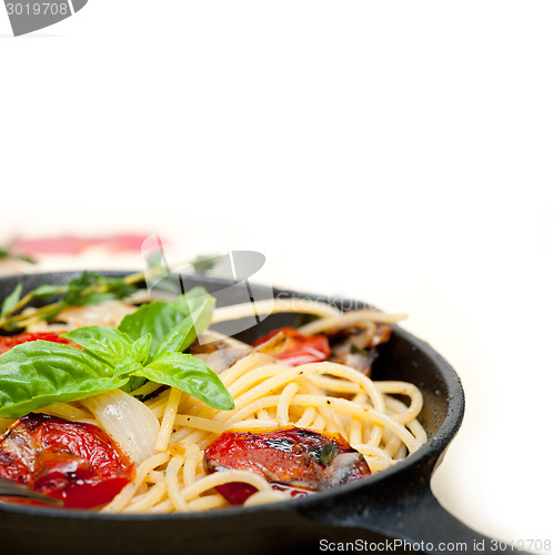 Image of spaghetti pasta with baked cherry tomatoes and basil 