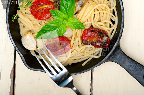 Image of spaghetti pasta with baked cherry tomatoes and basil 