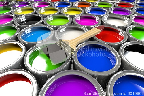 Image of Multiple open paint cans with a brush. 