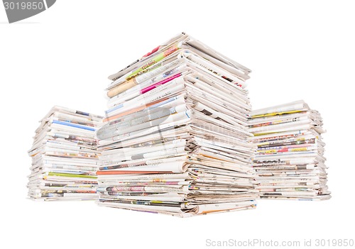 Image of Three big stacks of newspapers