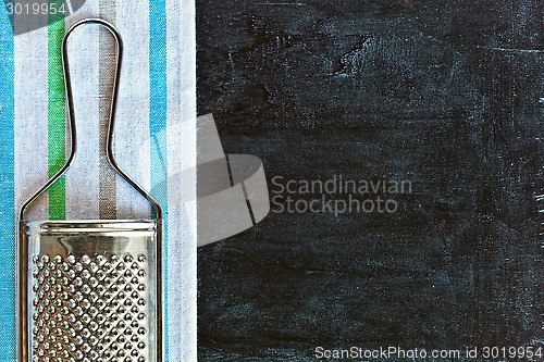 Image of metal grater and tablecloth 