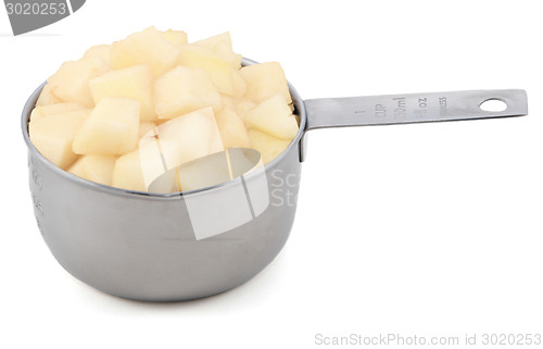 Image of Diced pear flesh in a cup measure