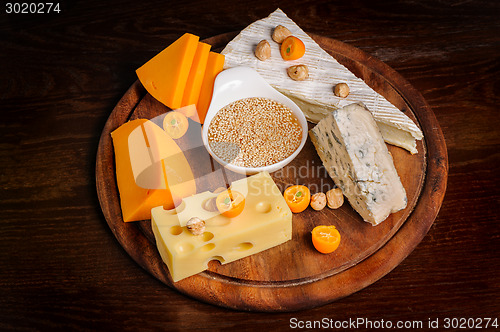 Image of various cheeses with nuts and fruits