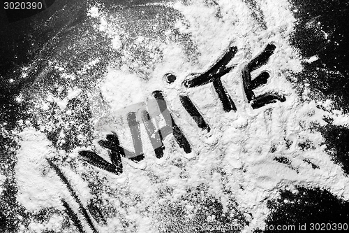 Image of White flour on black background