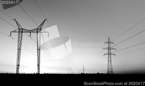 Image of Large transmission towers at sunset