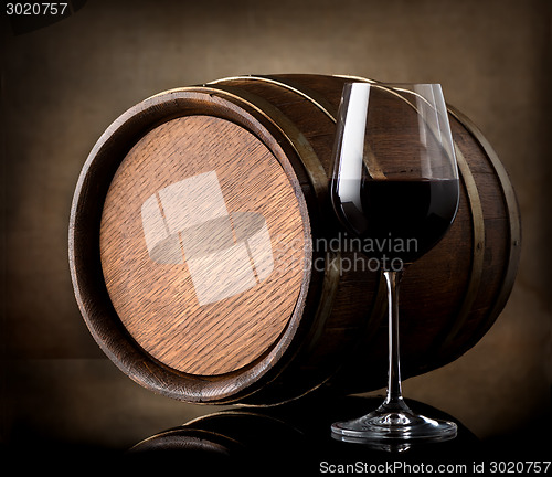 Image of Red wine and a wooden barrel