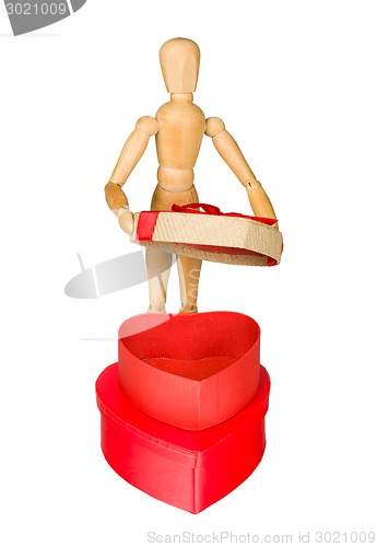 Image of Wooden mannequin opens heart shaped gift box