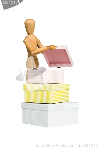 Image of Wooden mannequin opens little box