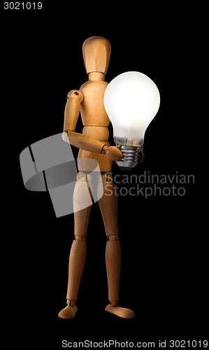 Image of Wooden mannequin holding light bulb