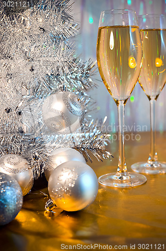 Image of Christmas tree, toy balloons and glasses of wine